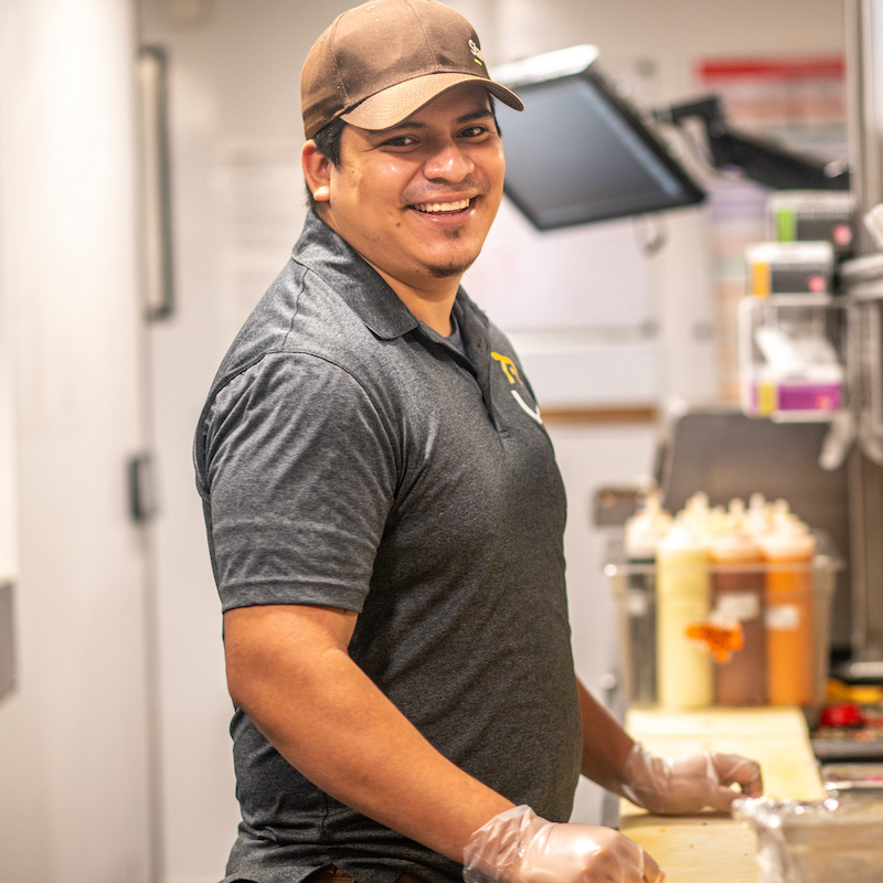 Starbird Chicken employee smiling